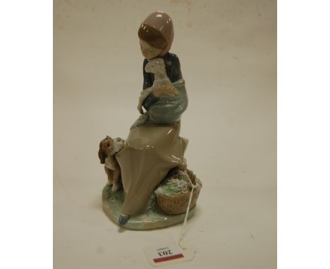 A Lladro figure of a seated girl holding a lamb with dog at her feet, impressed mark verso, h.22cm