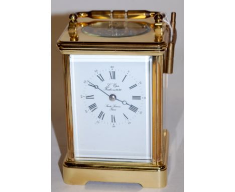 A l'Epee of France lacquered brass case carriage clock having visible platform escapement, twin barrel going eight day moveme
