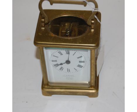 An early 20th century lacquered brass cased carriage clock, having enamelled dial with Roman numerals, signed W M Mossman of 