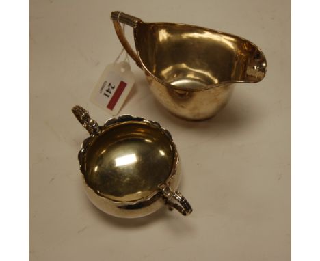 A George III silver helmet shaped cream jug; together with an early 20th century silver twin handled sugar bowl (2)