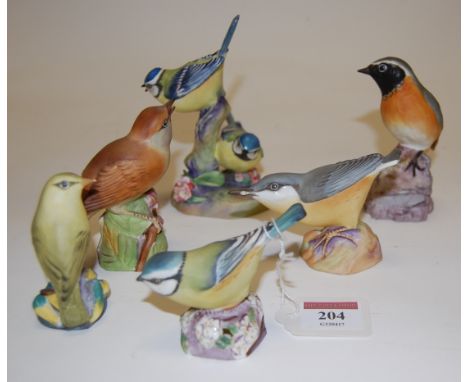 A collection of six Royal Worcester bird figures to include; 2x Blue Tit, Wood Warbler, Nightingale, Nuthatch, and Redstart