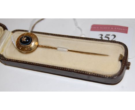 A 19th century yellow metal, black onyx, and diamond set mourning tie-pin, annotated 'In memory of', w.1.4cm, in fitted leath