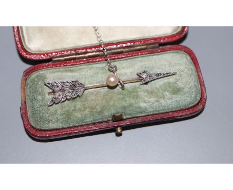 A Victorian yellow metal, rose cut diamond and pearl set arrow brooch, 45mm, gross 2.4 grams, in fitted box.CONDITION: One st