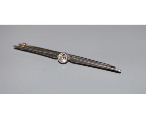 A white metal and solitaire diamond set bar brooch, 56mm, gross 3.3 grams.CONDITION: Diamond approximately 0.30ct, with an es