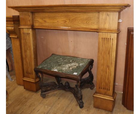 A reproduction oak fire surround, W.153cm H.124cm