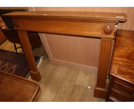 A reproduction pine fire surround, W.125cm H.102cm