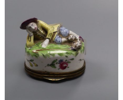 A Continental porcelain snuff box, modelled as a recumbent shepherd, height 6.5cm