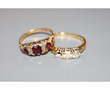 An early 20th century yellow metal, ruby? and diamond chip set ring and a modern 18ct gold and two(ex 3) stone diamond ring, 