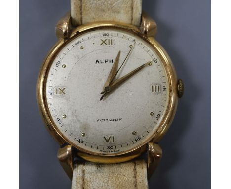 A gentleman's Swiss 750 yellow metal Alpha manual wind wrist watch, on associated strap, with case back inscription and no gl