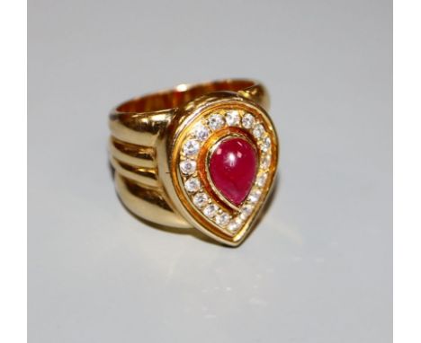 A modern 750 yellow metal, pear shaped cabochon ruby and diamond set dress ring, size N, gross 17.2 grams.CONDITION: A few mi