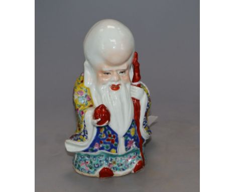 A Chinese famille rose figure of Shou Lao, height 15cmCONDITION: A small patch of loss of veneer to the fruit, minor glaze im