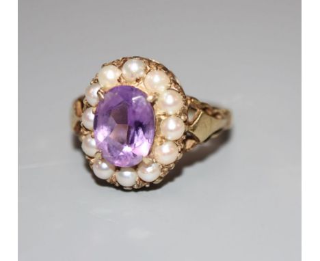 A 9ct, amethyst and split pearl set oval dress ring, size L, gross 3.6 grams.CONDITION: Two pearls have a slightly blistered 
