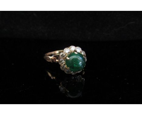 A gold ring with central emerald cabochon and diamonds, unmarked. Size Q, 3.2g 