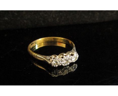 An 18ct gold platinum set three stone diamond ring in illusion setting. Size R, 2.3g 