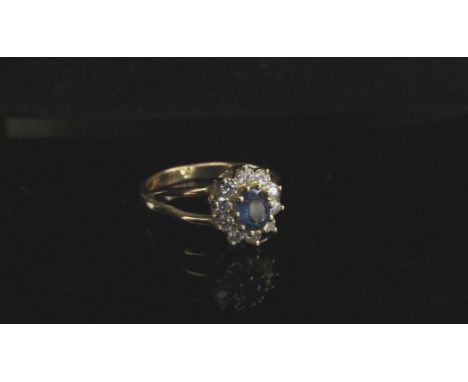 A 14ct gold ring, central oval sapphire framed by diamonds, open shoulders. Size P, 3.3g 