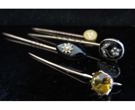 Two Victorian memoriam stick pins, black enamel and jet with pearl examples, a gold diamond set and citrine coloured stone se