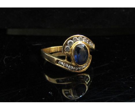 A sapphire and clear stone dress ring, stamped AU750. Size S, 3.7g 