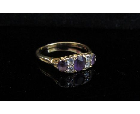 An 18ct gold amethyst and diamond dress ring. Size V, 4.1g 