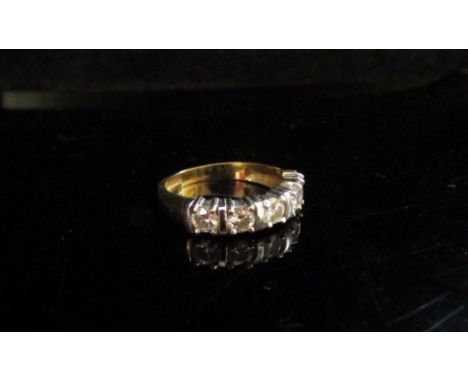 An 18ct gold ring set with five clear stones. Size K/L, 3.7g 