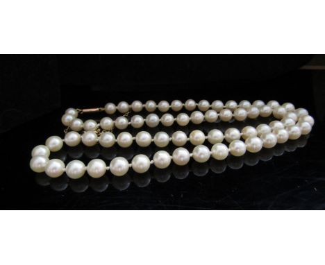 A single strand pearl necklace, 5mm pearls, 48cm long with a gold clasp stamped 9ct and safety chain 
