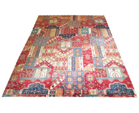 KAZAK PATCHWORK CARPET, 364cm x 270cm, of various polychrome designs on ruby field. 