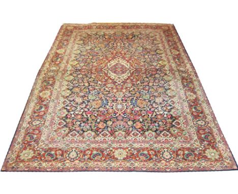 EXTREMELY FINE DABIR KASHAN CARPET, 358cm x 271cm, kurk wool, of ruby and ivory medallion on sapphire field with scrolling vi