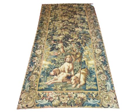VERY FINE VERDURE TAPESTRY, 250cm x 117cm, decorated with hounds and hunting trophies beneath a chestnut tree within floral b