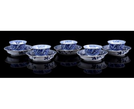 5 porcelain cups and saucers with blue and white floral decor with roosters in rim and bird near tree, Kangxi marked, China 1