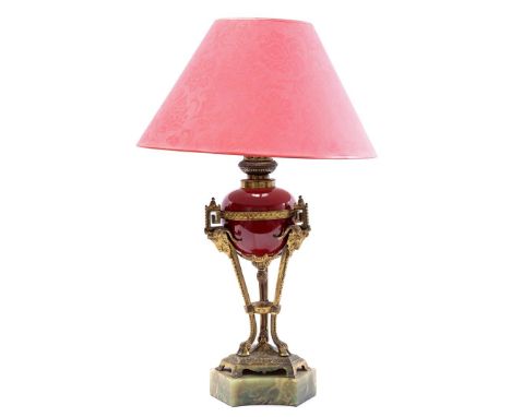 Classic model table table lamp with richly worked brass frame with ram's heads and goat feet decoration, red porcelain pot an