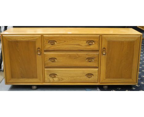 Ercol Blonde elm sideboard, of three drawers flanked by two single cupboards, 156 x 49 x 69 cm H. Not available for in-house 