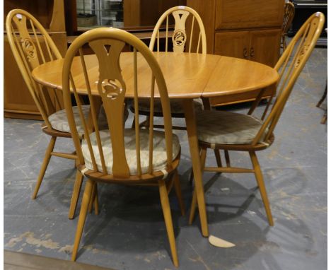 Ercol Blonde elm circular dining table, drop-leaf, with a set of four swan-back chairs, table D: 114 cm. Not available for in