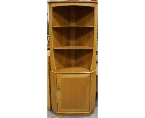 An Ercol Golden Dawn elm floor standing corner cupboard, having three open shelves above a single door base, W: 76 cm, H: 180