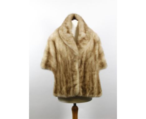 A circa 1960's light blond mink stole, with self lined collar to draping front panels, fully lined with floral detail fabric 