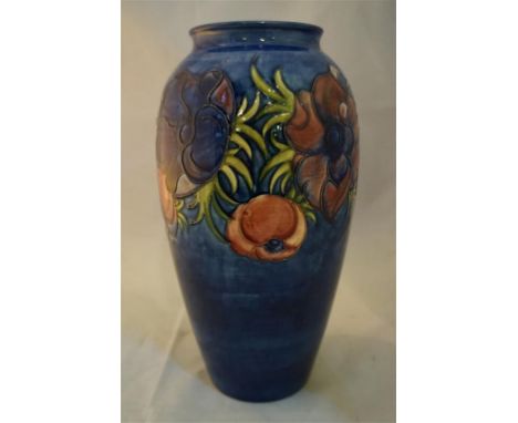 A Moorcroft Pottery vase of tapering cylindrical form decorated in anemone pattern on a blue ground, impressed factory marks,