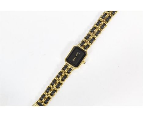 Chanel: A circa 1980's ladies gold plated quartz wristwatch, the black dial with faceted crystal glass to octagonal gold plat