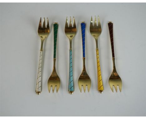 A set of six Danish sterling silver and enamel pickle forks, having gilt and coloured enamelled decoration, fitted in origina