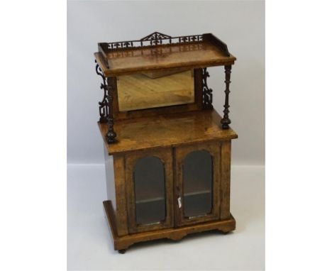 A Victorian marquetry inlaid burr walnut veneered music cabinet, the upper tier with three quarter fretwork gallery above the