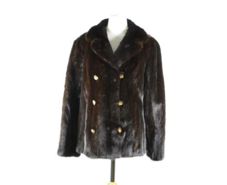 A circa 1970's chocolate brown mink jacket, hip length, of fitted form with self lined double collar, and three pairs of feat