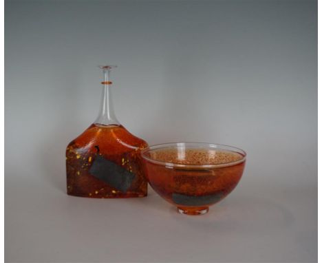 Two pieces of Kosta Boda glassware to include a bottle vase, and a pedestal bowl, each having mottled multi coloured decorati