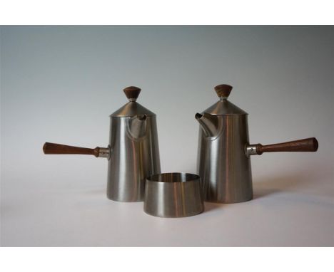 An Old Hall stainless steel three piece tea service designed by Robert Welch, comprising hot water jug, teapot, each with sid