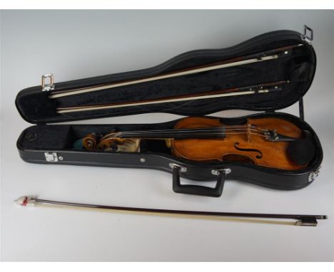 A cased violin and three various unmarked bows, the violin bearing label for Josef Klotz in Mittenwalde Anno 1795, together w