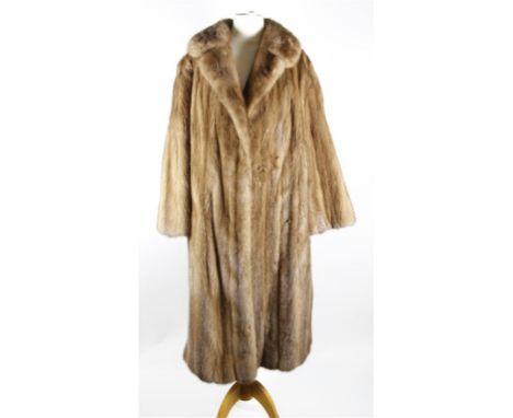 A circa 1960's light brown mink swing coat, knee length with self lined double collar, hook fastening to front, slit pockets 