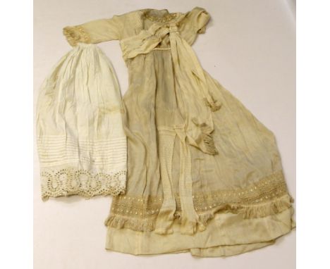 An early 20th century wedding outfit, to include a pale ivory silk wedding dress, with pin pleated shoulders to high waist wi