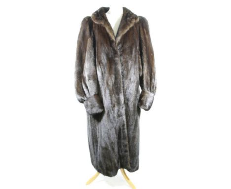 A late 1970's/early 1980's full length chocolate brown mink coat, with self lined collar and triple clip fastening to front, 