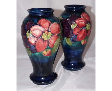 A pair of Moorcroft Pottery vase of inverted baluster form, decorated in a Clematis pattern on green and blue ground, blue si