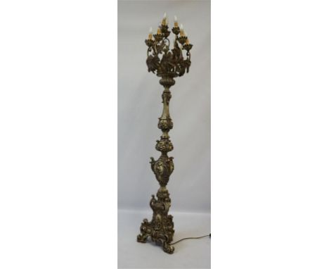 A large and ornate Period-style floor standing light, the nine scrolling leaf form branches above the ornate tapered column d