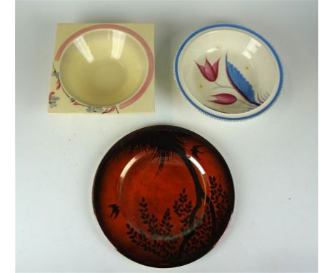 Three pieces of Art Deco ceramics to include a Carltonware lustre circular cabinet plate, decorated with birds in eventide la