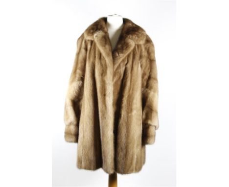 A circa 1960's light brown mink fur three quarter length swing coat, with wide self lined double collar, hook fastenings to f