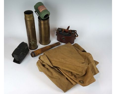 A World War I period imperial German stick grenade handle, a grenade top, two brass shell cases, a gas cape, a pair of binocu