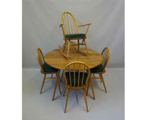 An Ercol light elm drop leaf dining table together with four spindle back chairs, also a spindle back rocking chair CONDITION